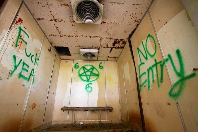 a lift with satanic graffiti at old changi hospital