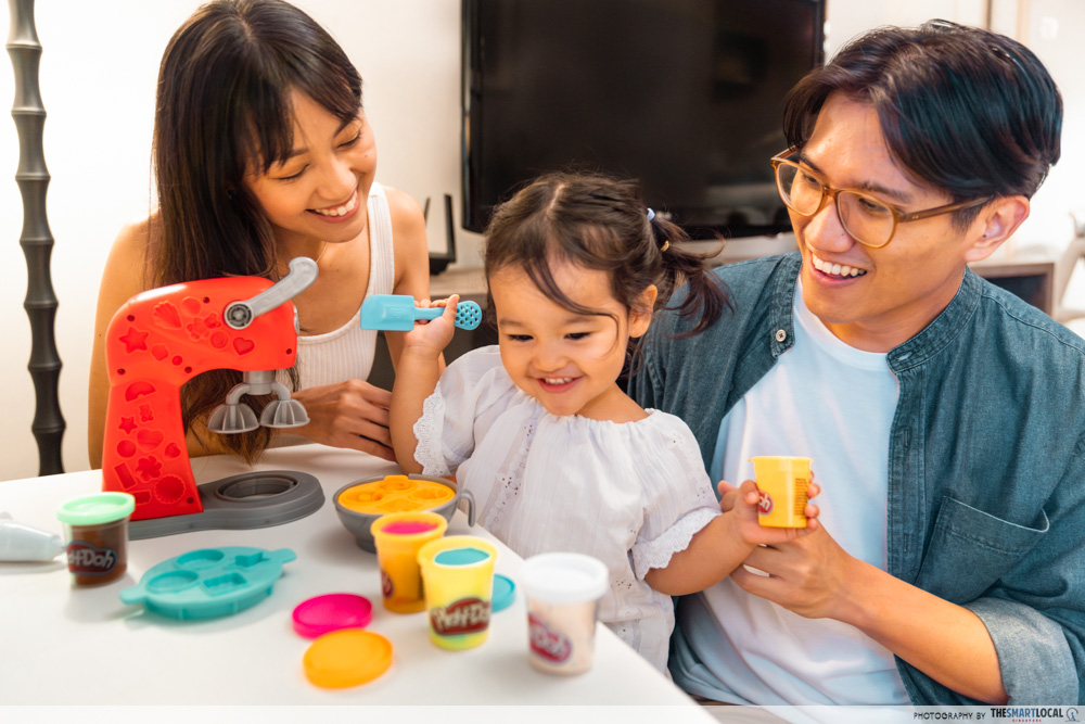Couple playing Play-Doh with child