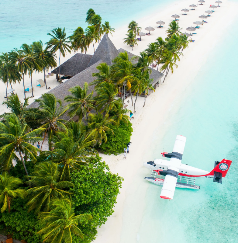 Maldives island with seaplane at shore