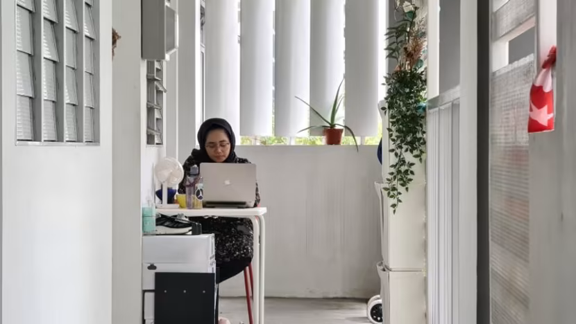 HDB corridor transformations in Singapore - Woman studying in HDB Corridor