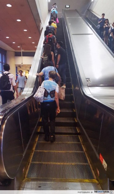 Things in Singapore That Feel Illegal But Aren't - standing on the left side of the escalator