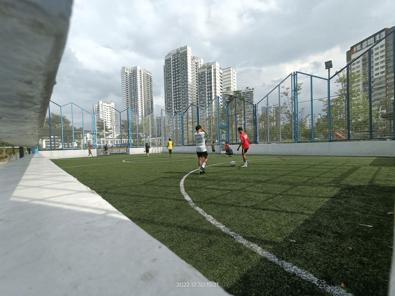 Futsal courts in SG - People playing in artificial field court 