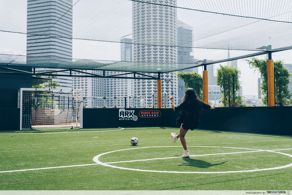 Futsal courts in SG - Woman kicking a ball to goal 