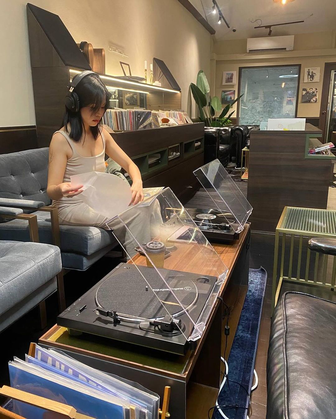 New cafes & restaurants in June 2024 - woman listening to music on sofa at Slowbytes 