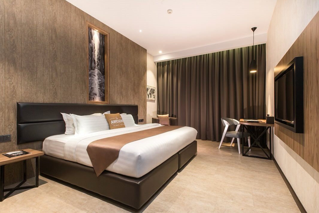 Iconic Hotel Penang bedroom with floor-to-ceiling curtains