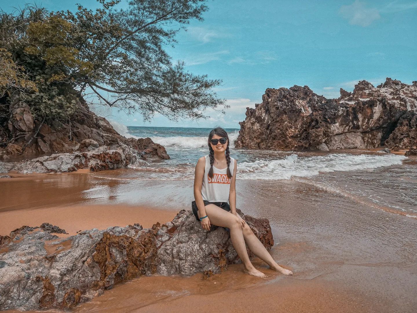 Talent sitting on rocks at Cherating Beach shore 