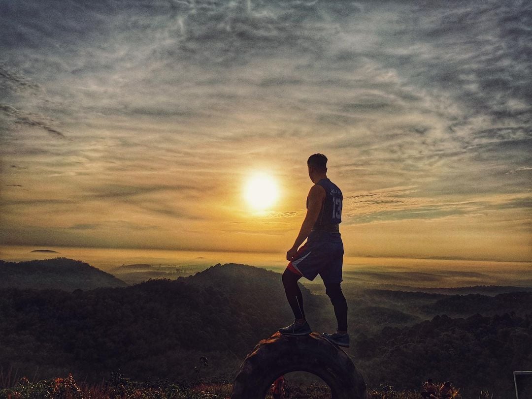 Man at summit of Bukit Jementah golden hour