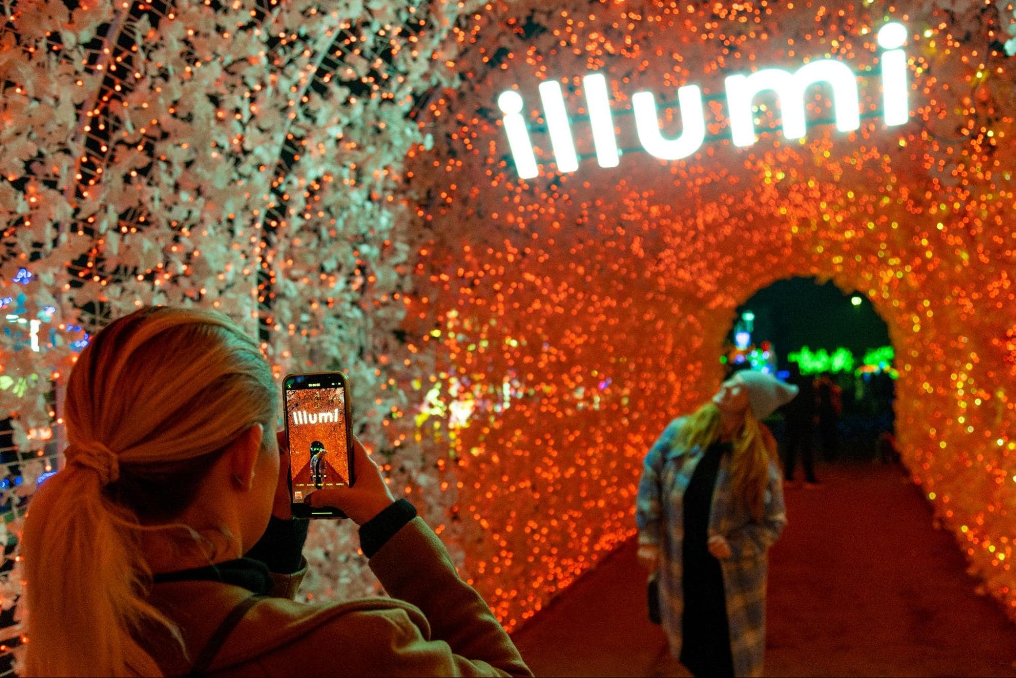 People taking pictures at illumi Singapore 2024
