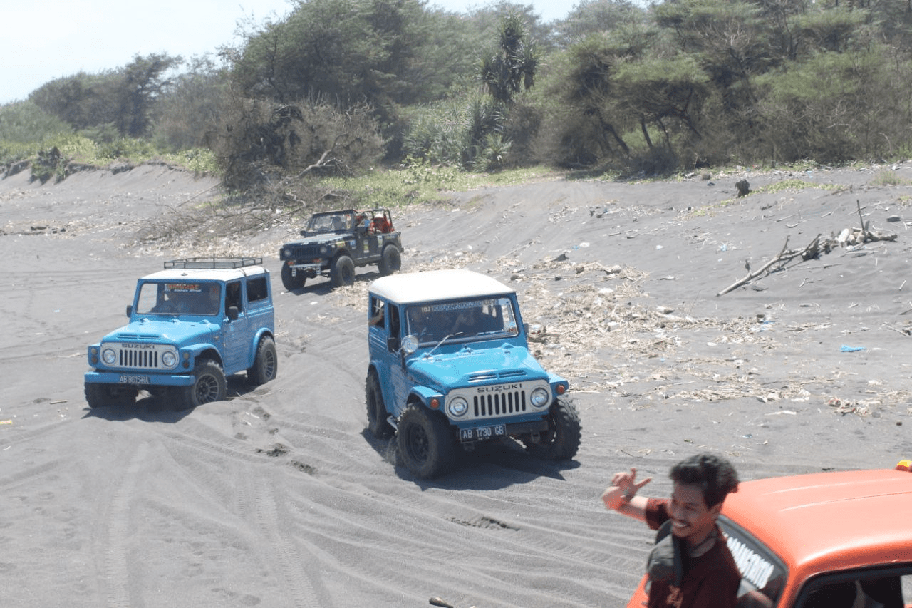 Jeep cars driving on sand dunes