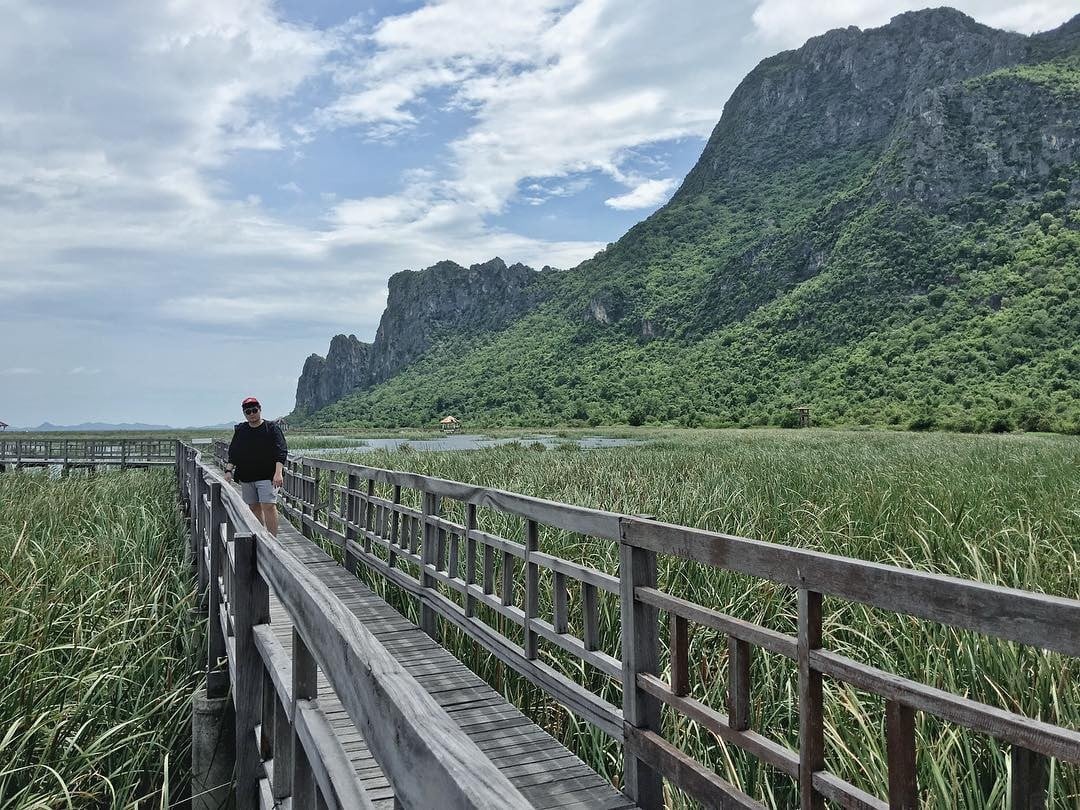 Bangkok Day Trips - Man walking on Bueng Bua Wood Boardwalk 