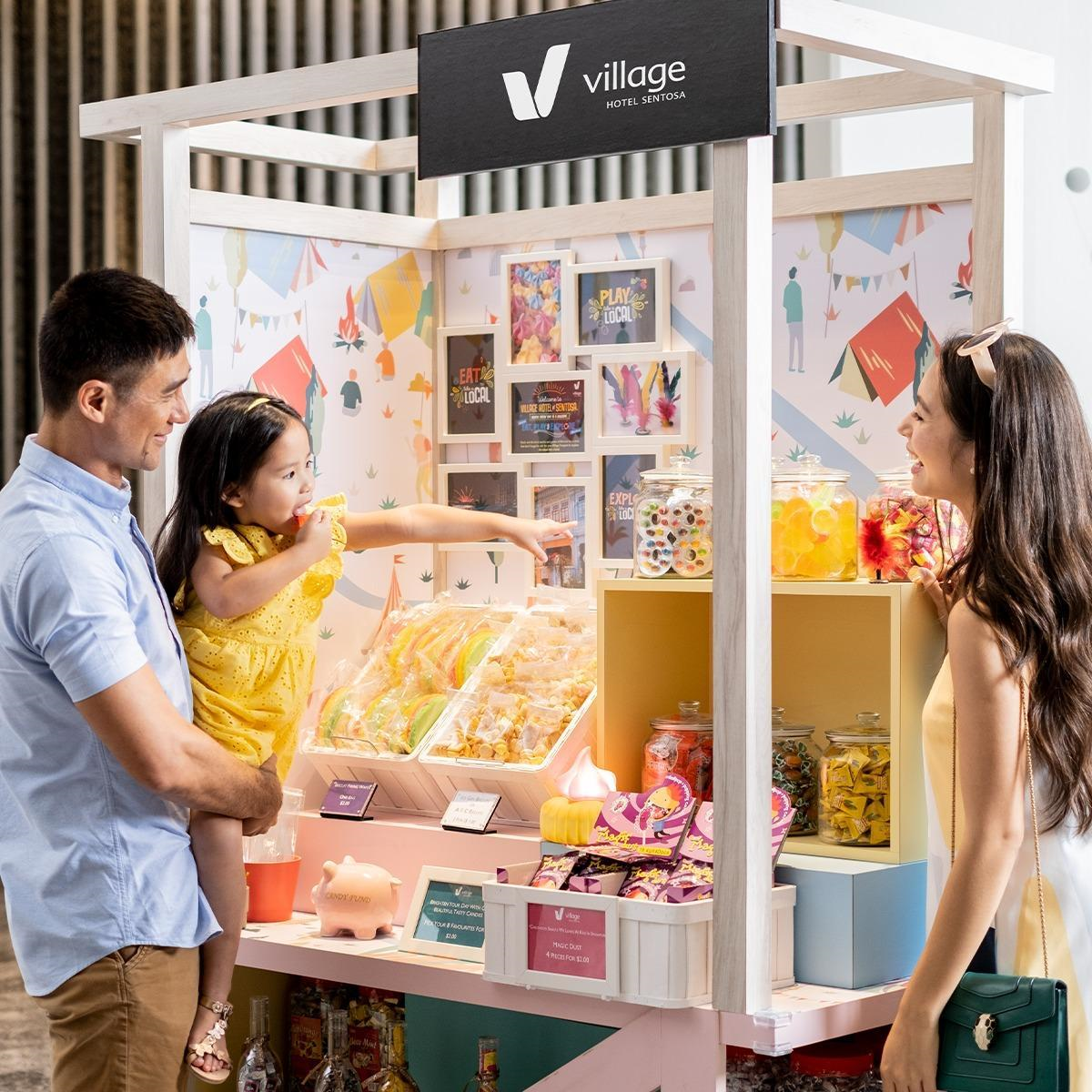 Little girl points out what she wants from the village cart 