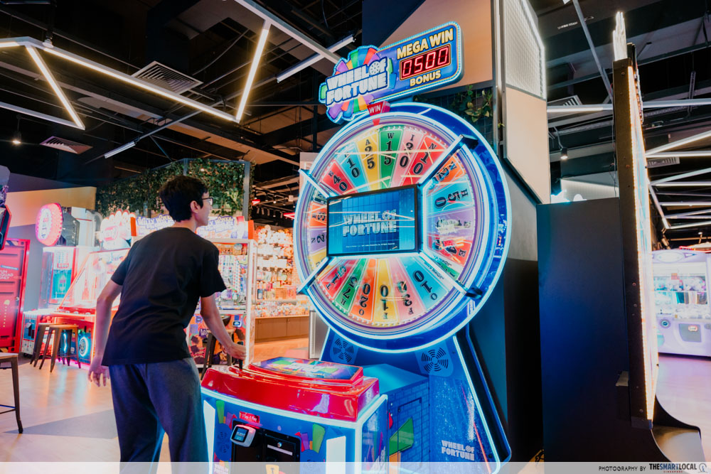 tall guy in Singapore - slouching at arcade stations 