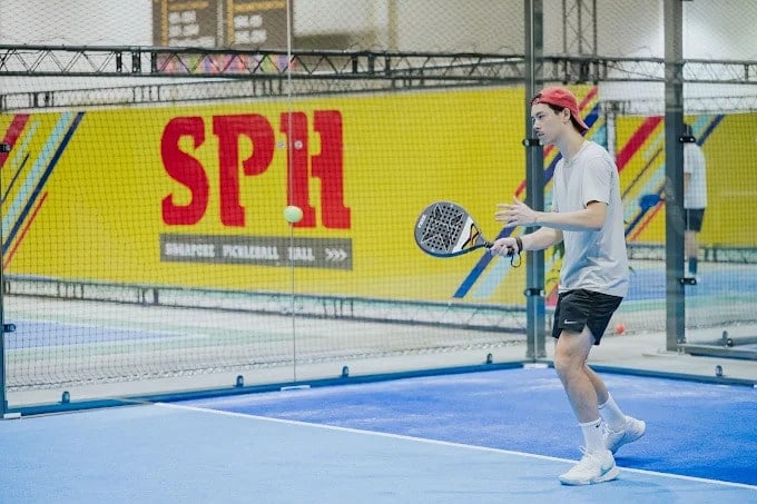 Guy playing pickleball