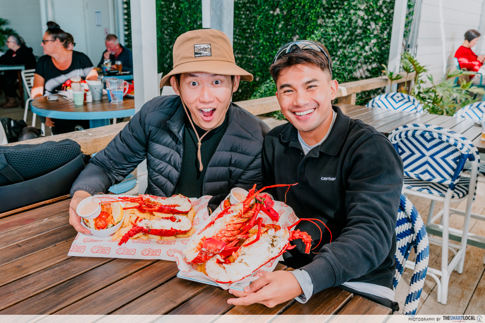 men enjoying lobsters