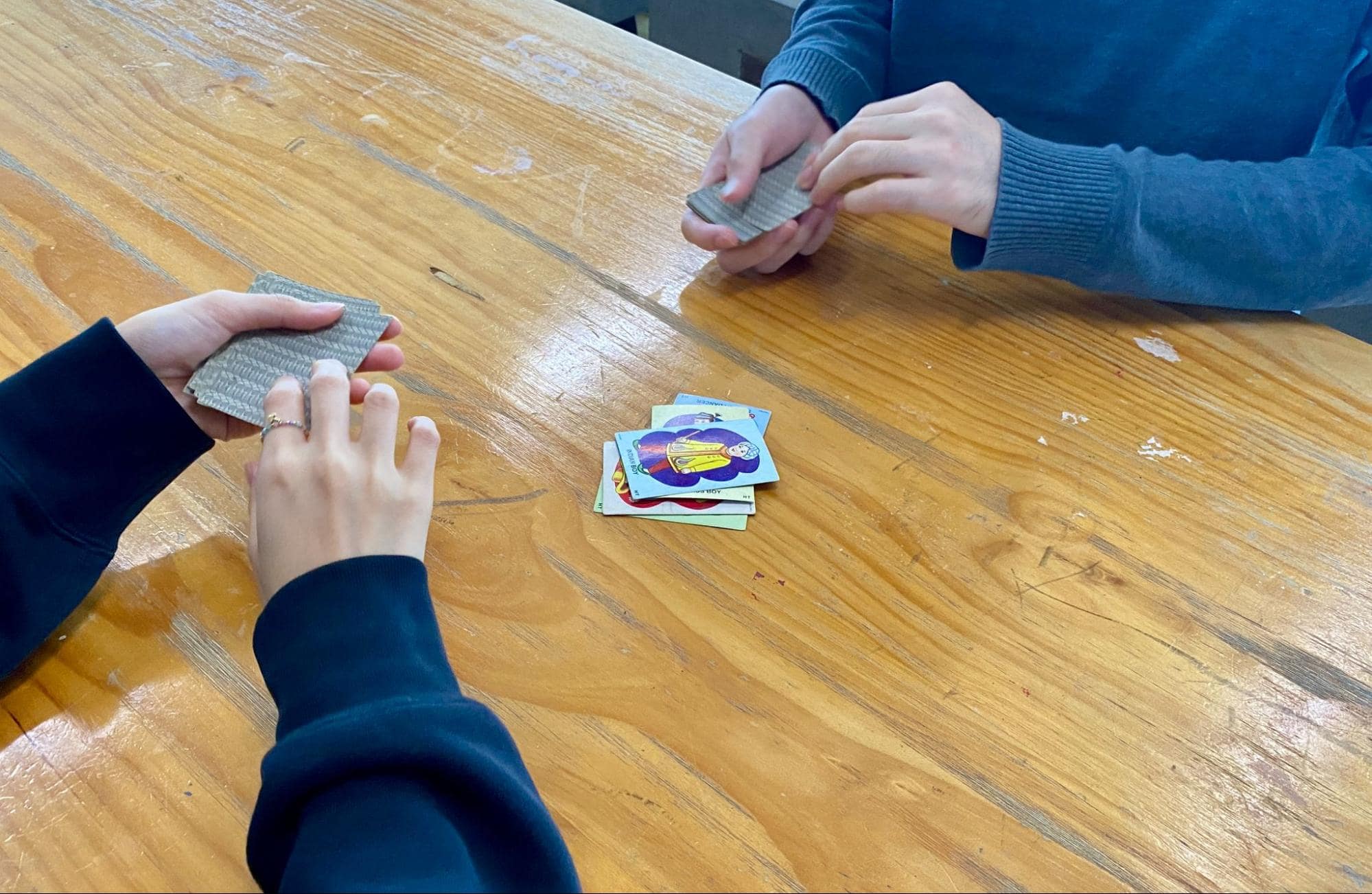 Card and board games - two people playing a game of Snap