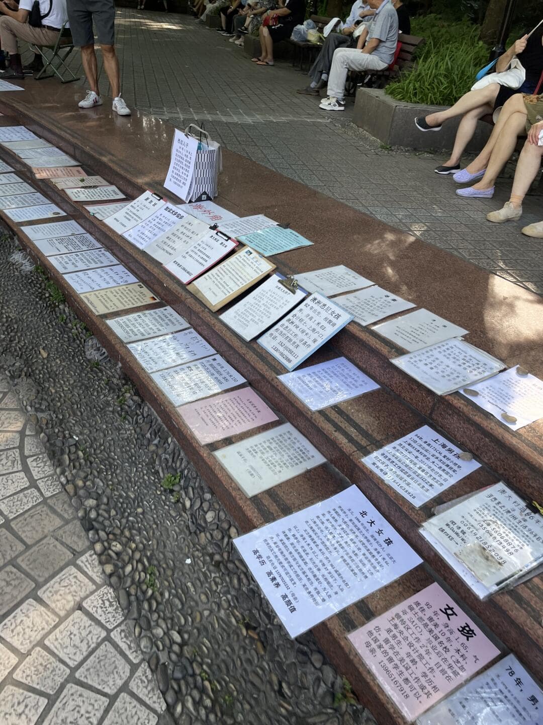 Shanghai Itinerary - posters laid on the ground at the People's Park Marriage Market