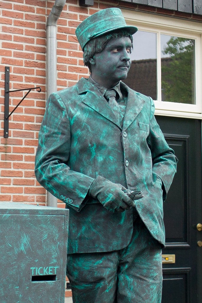 Unique Jobs - a human statue dressed in a realistic metallic costume
