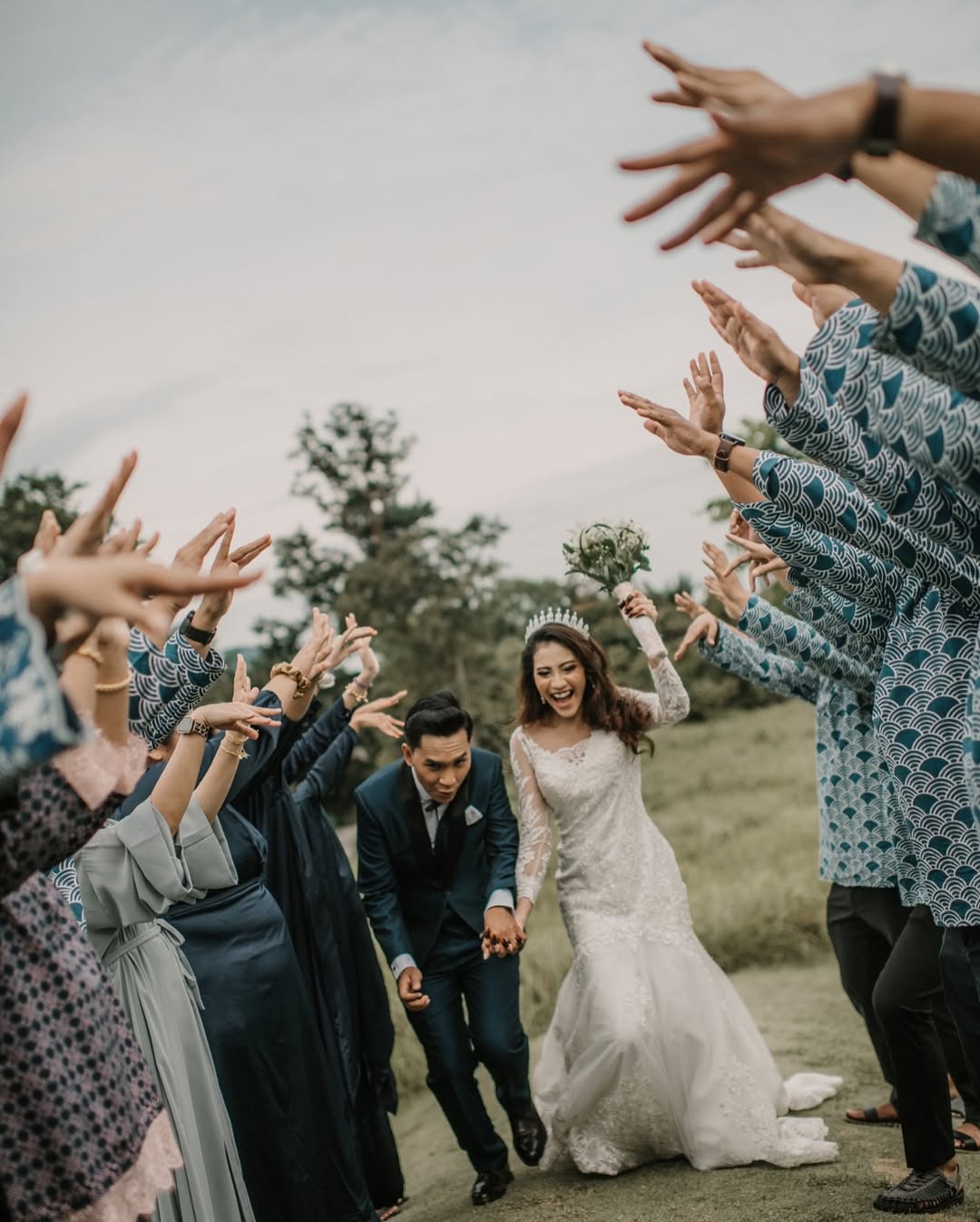 Unique Jobs - bridesmaids and groomsmen lined up together as the couple runs between them