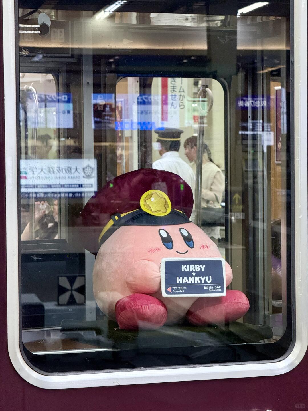 kirby train - plushie with conductor hat on the train