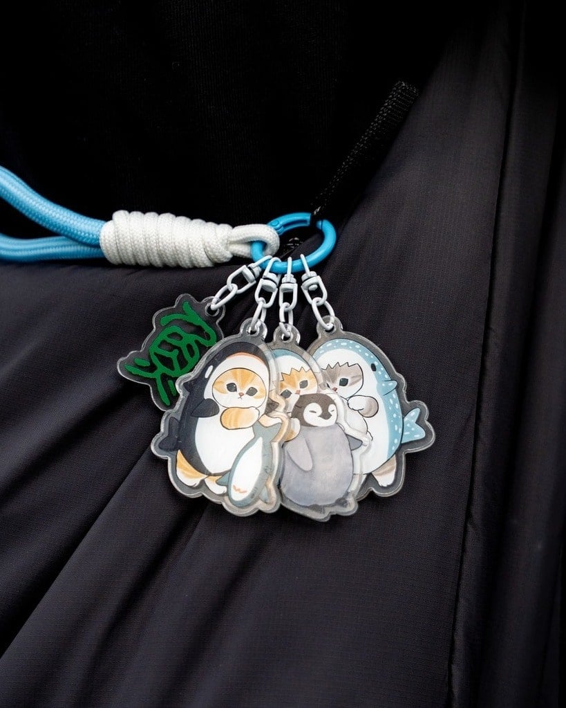 The Mofusand Shark Meow acrylic keychain on a bag