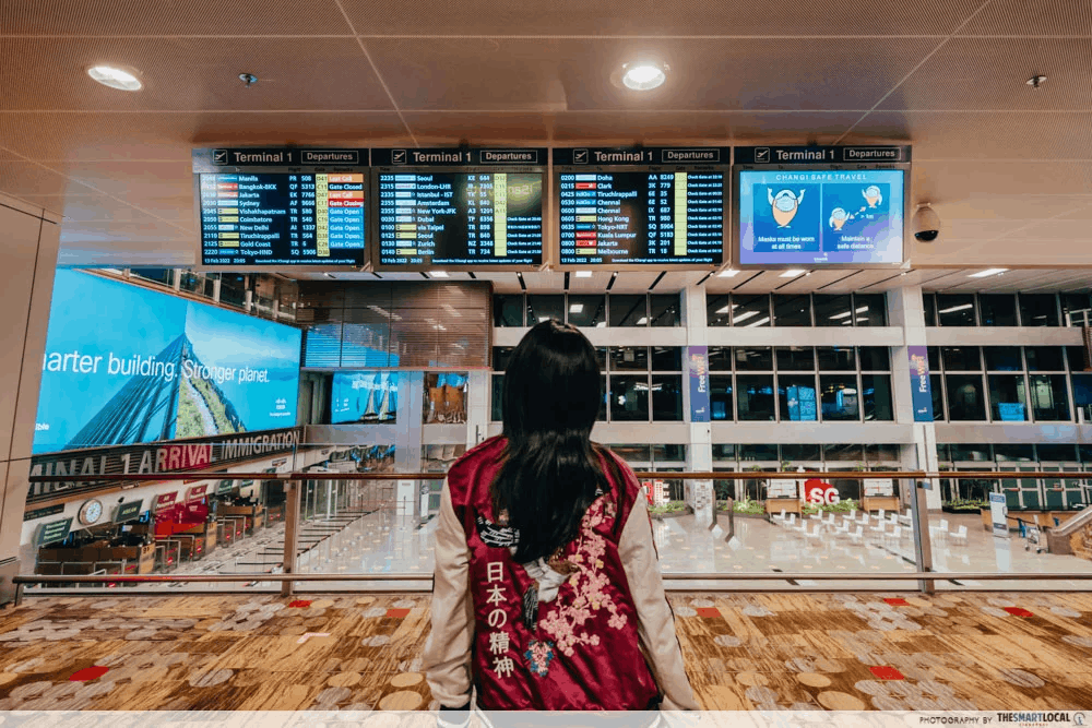 Checking the flight boards at the airport