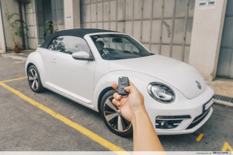 Hand pointing at a car