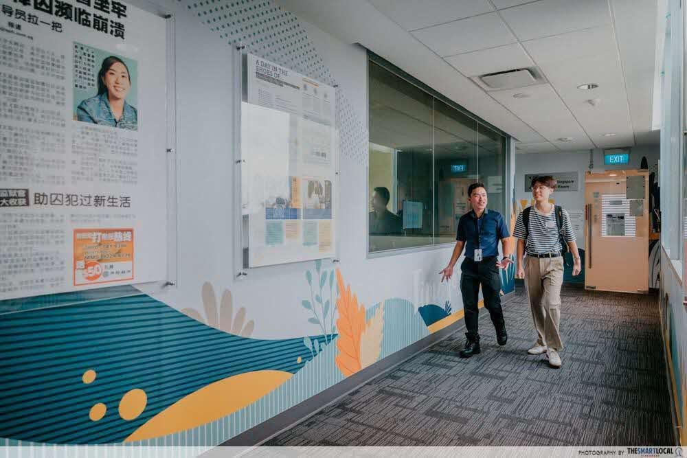 Mr Loh walking down a corridor