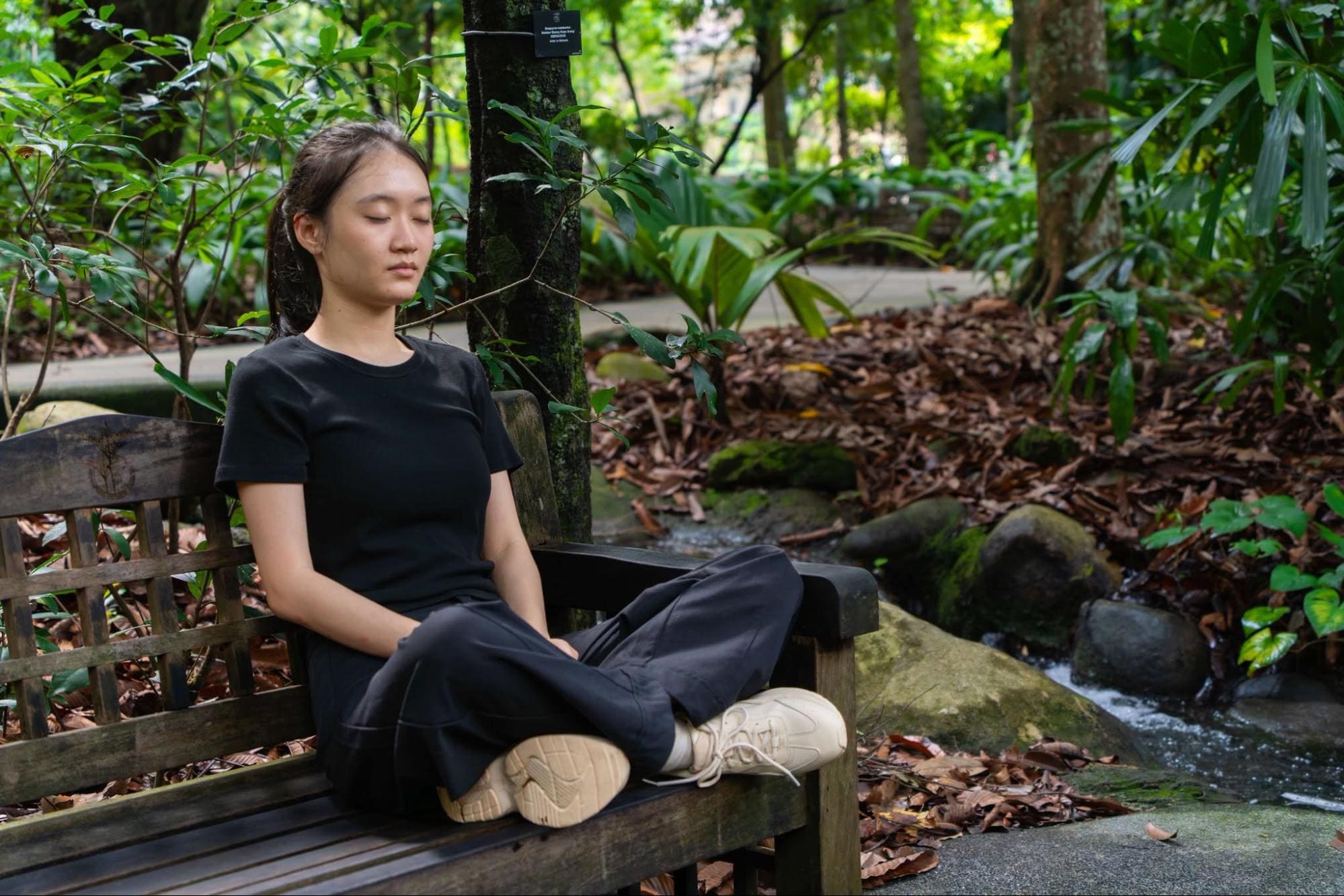 Sitting on a bench along the Nature Immersion Trail
