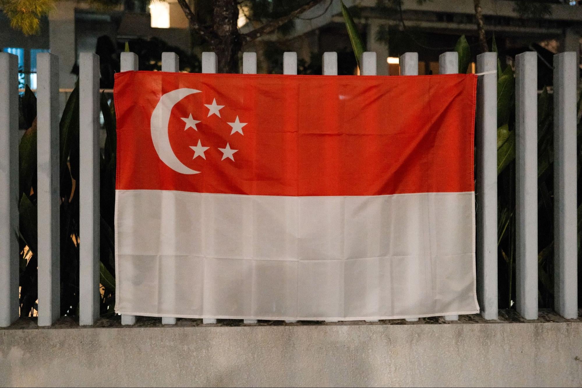 Singapore flag displayed on a railing