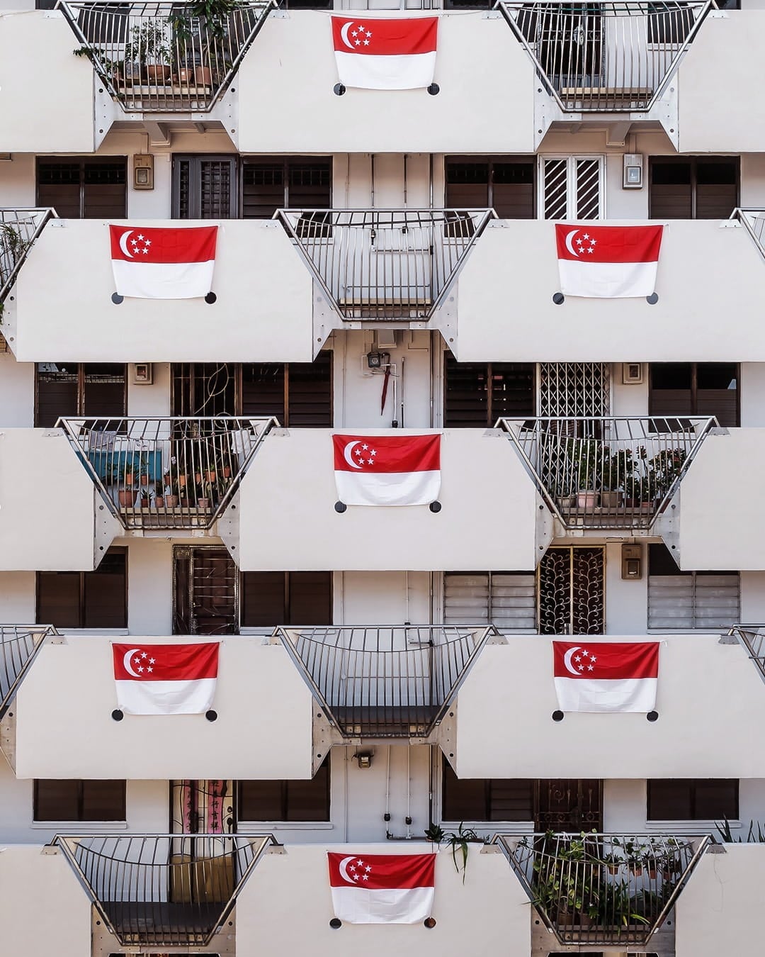 Singapore flags hung up on a HDB block